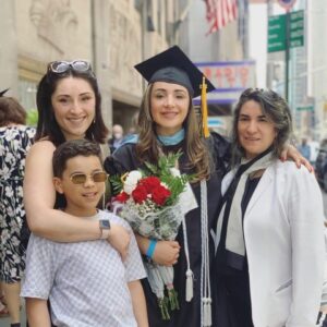 Kassandra Ruiz at her Pratt Institute Commencement, where she served as the Graduate Commencement Speaker. Ruiz is with her sister Kimberly Ruiz, nephew Gavin Fontanez, and mother Luisa Ruiz.